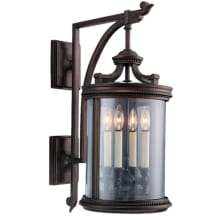 Louvre Four-Light Outdoor Wall Sconce with Antiqued Candles and Clear Blown Glass Shade