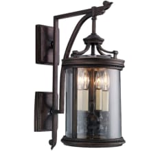 Louvre Four-Light Outdoor Wall Sconce with Antiqued Candles and Clear Blown Glass Shade