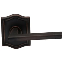 Wedge Passage Door Lever Set with Arched Style Rose from the Prodigy Collection