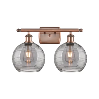 A thumbnail of the Innovations Lighting 516-2W-11-18 Athens Deco Swirl Vanity Antique Copper / Light Smoke Deco Swirl