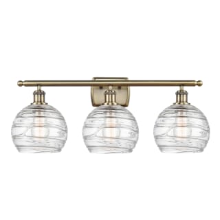 A thumbnail of the Innovations Lighting 516-3W-11-26 Athens Vanity Clear Deco Swirl / Antique Brass