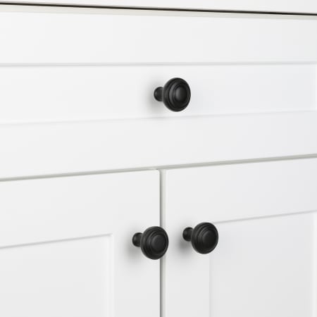 A large image of the Ageless Iron 600929 Black Rustic Cabinet Knob - Lifestyle