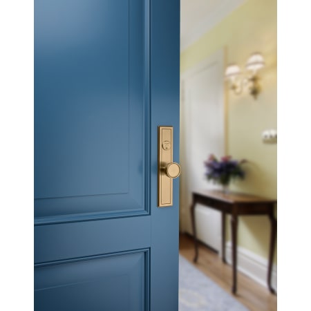 A large image of the Baldwin 6945.DBLC Baldwin-6945.DBLC-Satin Brass and Brown installed on blue door