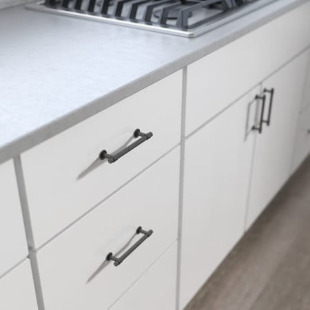 A large image of the Franklin Brass P29617K-B Soft Iron Hardware on White Cabinetry