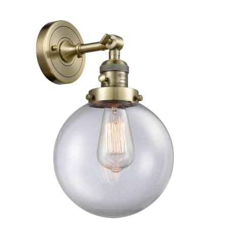 A large image of the Innovations Lighting 203SW-8 Beacon Antique Brass / Clear