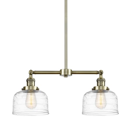 A large image of the Innovations Lighting 209-10-21 Bell Linear Antique Brass / Clear Deco Swirl