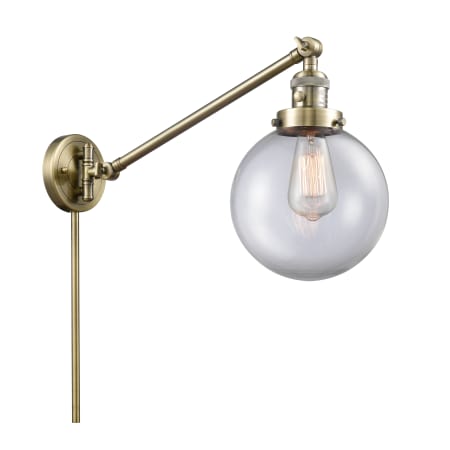 A large image of the Innovations Lighting 237-8 Beacon Antique Brass / Clear
