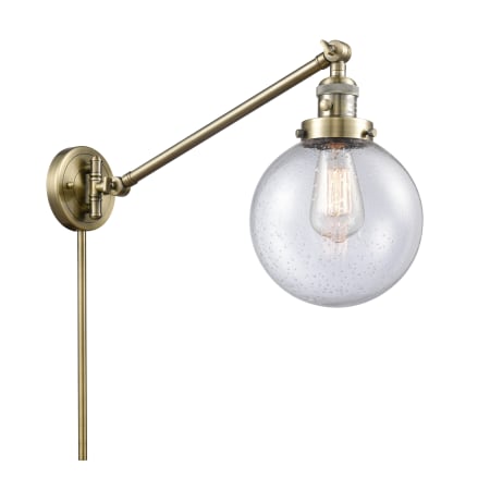 A large image of the Innovations Lighting 237-8 Beacon Antique Brass / Seedy
