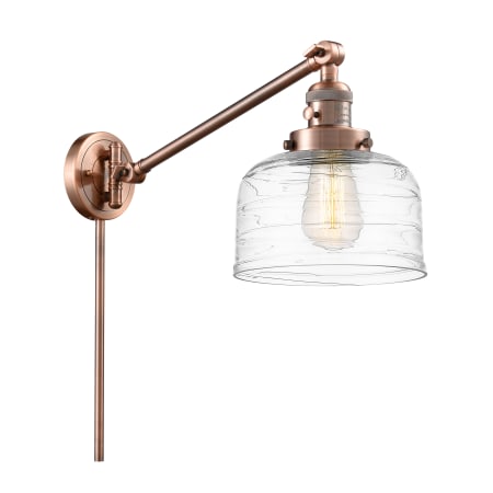 A large image of the Innovations Lighting 237-25-8 Bell Sconce Antique Copper / Clear Deco Swirl