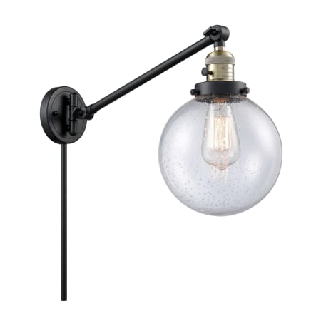 A large image of the Innovations Lighting 237-8 Beacon Black / Antique Brass / Seedy