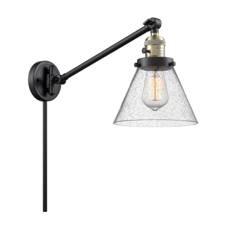 A large image of the Innovations Lighting 237 Large Cone Black / Antique Brass / Seedy