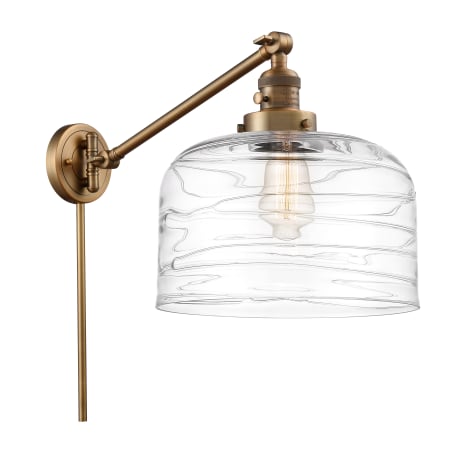 A large image of the Innovations Lighting 237-13-12-L Bell Sconce Brushed Brass / Clear Deco Swirl