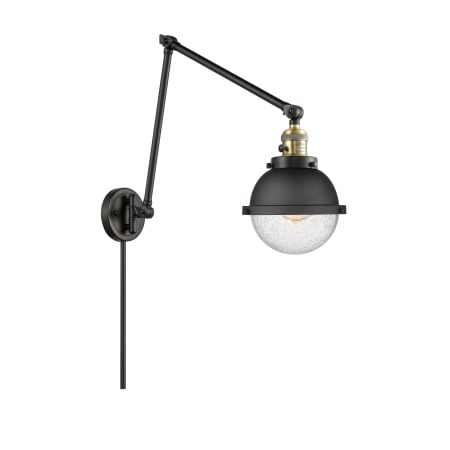 A large image of the Innovations Lighting 238-11-8 Hampden Sconce Black Antique Brass / Seedy