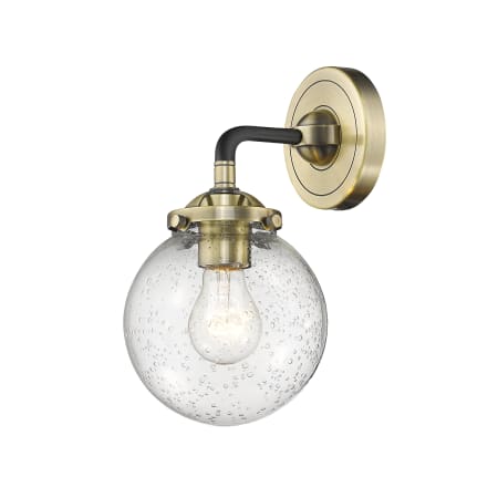 A large image of the Innovations Lighting 284-1W-6 Beacon Black Antique Brass / Seedy Globe