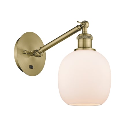 A large image of the Innovations Lighting 317-1W-13-6 Belfast Sconce Antique Brass / Matte White