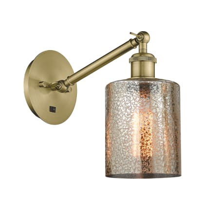 A large image of the Innovations Lighting 317-1W-12-6 Cobbleskill Sconce Antique Brass / Mercury