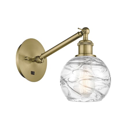 A large image of the Innovations Lighting 317-1W-12-6 Athens Sconce Antique Brass / Clear Deco Swirl