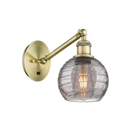 A large image of the Innovations Lighting 317-1W 8 6 Athens Deco Swirl Sconce Antique Brass / Light Smoke Deco Swirl