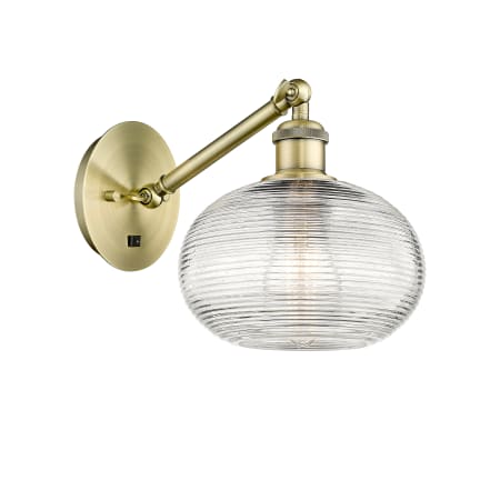 A large image of the Innovations Lighting 317-1W-9-8 Ithaca Sconce Antique Brass / Clear Ithaca