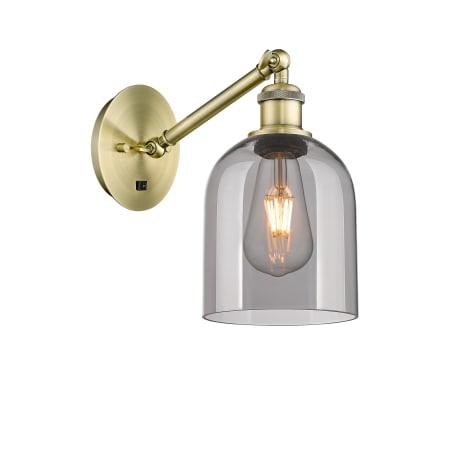 A large image of the Innovations Lighting 317-1W-10-6 Bella Sconce Antique Brass / Light Smoke