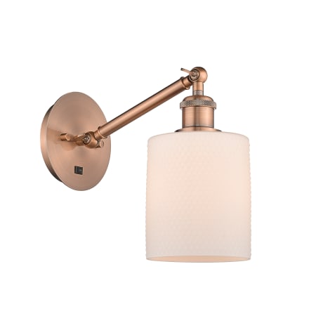 A large image of the Innovations Lighting 317-1W-13-6 Cobbleskill Sconce Antique Copper / Matte White