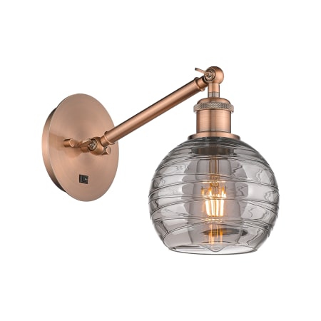 A large image of the Innovations Lighting 317-1W 8 6 Athens Deco Swirl Sconce Antique Copper / Light Smoke Deco Swirl