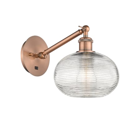 A large image of the Innovations Lighting 317-1W-9-8 Ithaca Sconce Antique Copper / Clear Ithaca