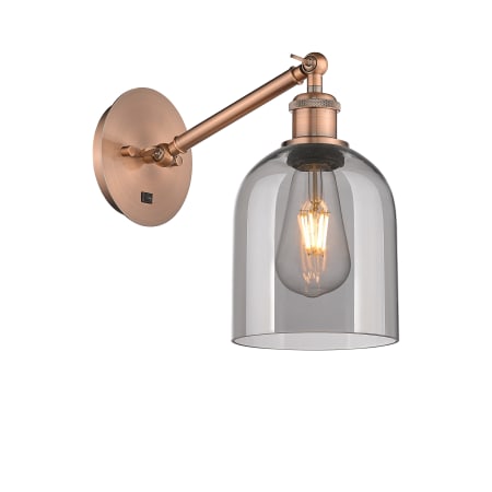 A large image of the Innovations Lighting 317-1W-10-6 Bella Sconce Antique Copper / Light Smoke