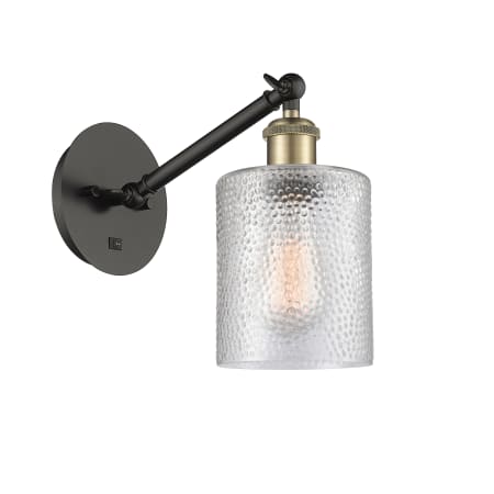 A large image of the Innovations Lighting 317-1W-13-5 Cobbleskill Sconce Black Antique Brass / Clear