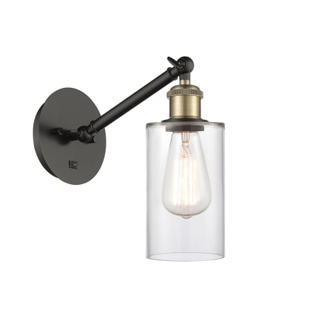 A large image of the Innovations Lighting 317-1W-13-5 Clymer Sconce Black Antique Brass / Clear