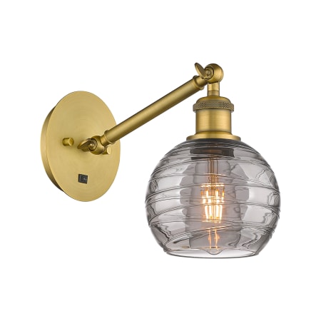 A large image of the Innovations Lighting 317-1W 8 6 Athens Deco Swirl Sconce Brushed Brass / Light Smoke Deco Swirl