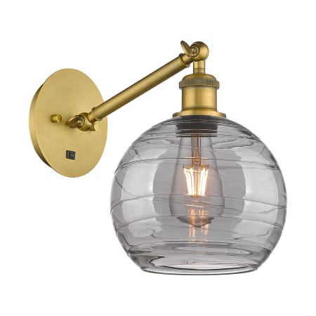 A large image of the Innovations Lighting 317-1W 10 8 Athens Deco Swirl Sconce Brushed Brass / Light Smoke Deco Swirl