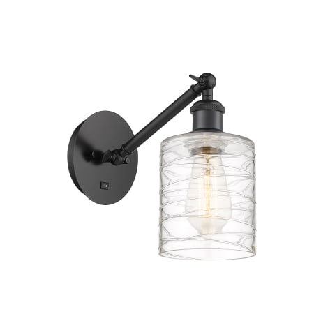 A large image of the Innovations Lighting 317-1W-13-5 Cobbleskill Sconce Matte Black / Deco Swirl