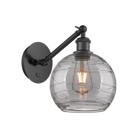 A large image of the Innovations Lighting 317-1W 10 8 Athens Deco Swirl Sconce Matte Black / Light Smoke Deco Swirl