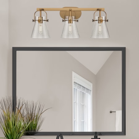 A large image of the Innovations Lighting 423-3W-10-27 Pilaster II Cone Vanity Alternate Image