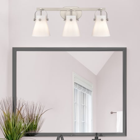 A large image of the Innovations Lighting 423-3W-10-27 Pilaster II Cone Vanity Alternate Image