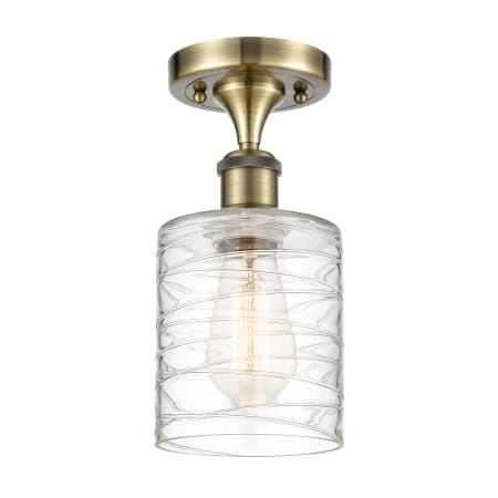 A large image of the Innovations Lighting 516-1C-13-5 Cobbleskill Semi-Flush Antique Brass / Deco Swirl