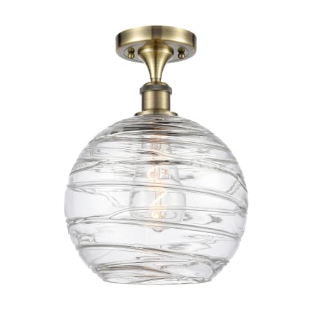 A large image of the Innovations Lighting 516-1C-15-10 Athens Semi-Flush Antique Brass / Clear Deco Swirl