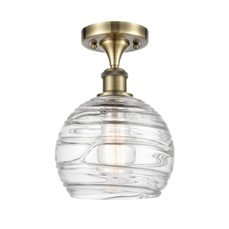 A large image of the Innovations Lighting 516-1C-13-8 Athens Semi-Flush Antique Brass / Clear Deco Swirl