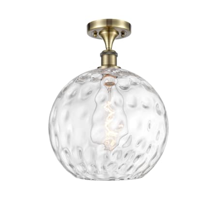 A large image of the Innovations Lighting 516-1C-17-12 Athens Semi-Flush Antique Brass / Clear Water Glass