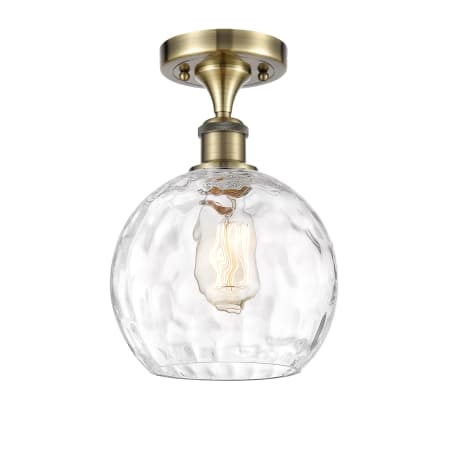 A large image of the Innovations Lighting 516-1C-13-8 Athens Semi-Flush Antique Brass / Clear Water Glass