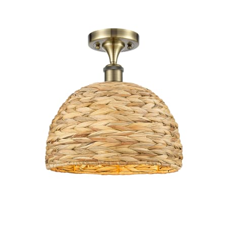 A large image of the Innovations Lighting 516-1C-13-12 Woven Rattan Semi-Flush Antique Brass / Natural