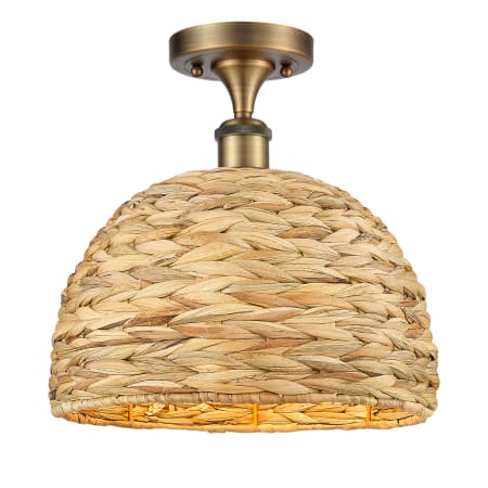 A large image of the Innovations Lighting 516-1C-13-12 Woven Rattan Semi-Flush Brushed Brass / Natural