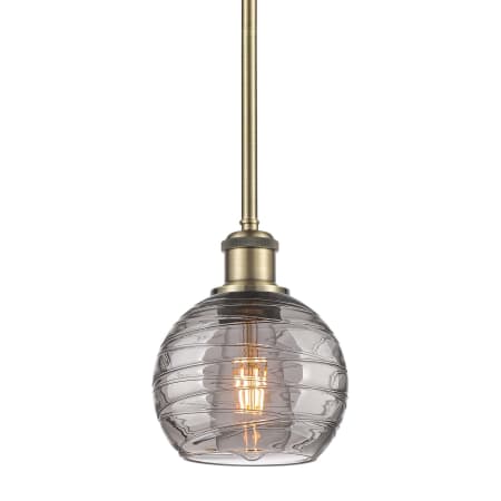 A large image of the Innovations Lighting 516-1S-9-6 Athens Deco Swirl Pendant Antique Brass / Light Smoke Deco Swirl