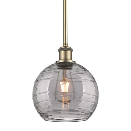 A large image of the Innovations Lighting 516-1S-10-8 Athens Deco Swirl Pendant Antique Brass / Light Smoke Deco Swirl