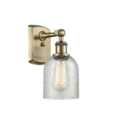 A large image of the Innovations Lighting 516-1W-12-5 Caledonia Sconce Antique Brass / Mica