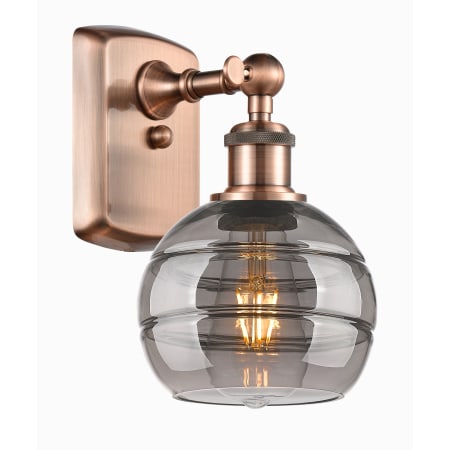 A large image of the Innovations Lighting 516-1W-9-6 Rochester Sconce Antique Copper / Light Smoke