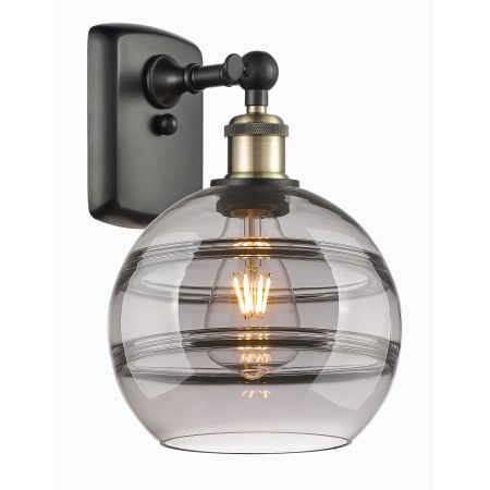 A large image of the Innovations Lighting 516-1W-11-8 Rochester Sconce Black Antique Brass / Light Smoke