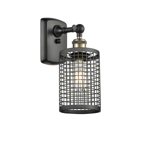 A large image of the Innovations Lighting 516-1W-13-5 Nestbrook Sconce Black Antique Brass / Matte Black