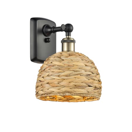 A large image of the Innovations Lighting 516-1W-12-8 Woven Rattan Sconce Black Antique Brass / Natural